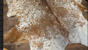 5x8 Brown and White Cow Hide Rug  rental Denver, CO